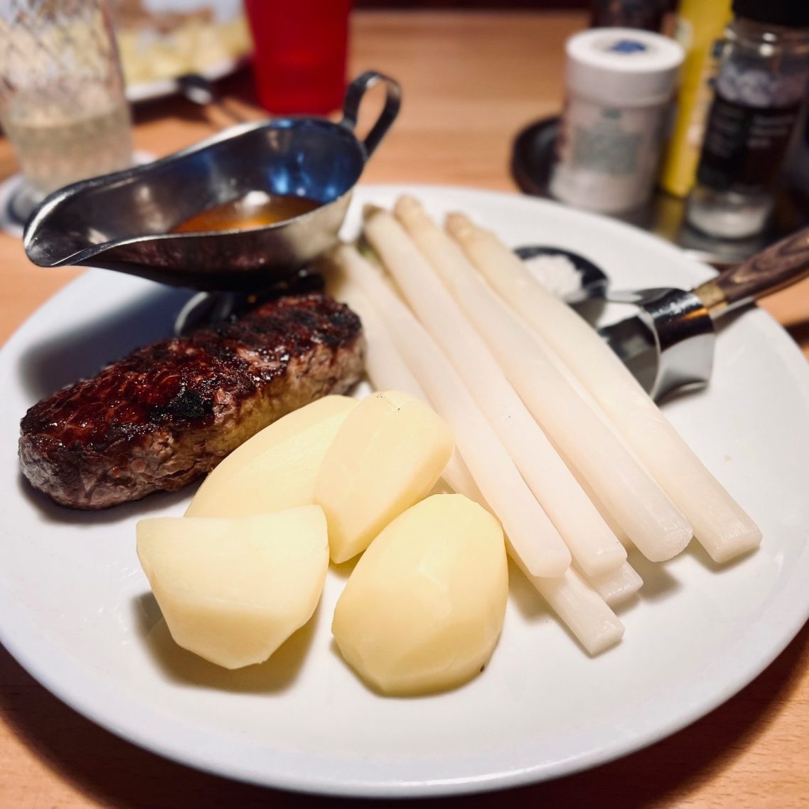 Ein Teller mit grüner Sauce, Kartoffeln und hartgekochten Eiern, garniert mit Schnittlauch.